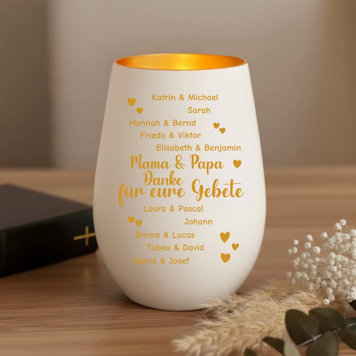 Windlicht auf einem Tisch neben einer Bibel